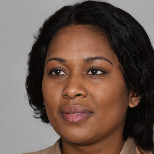 Joyful black young-adult female with medium  black hair and brown eyes