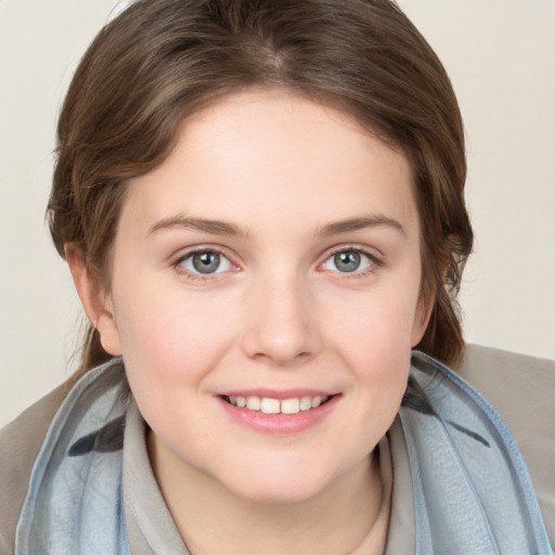 Joyful white young-adult female with medium  brown hair and blue eyes