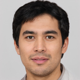 Joyful asian young-adult male with short  black hair and brown eyes