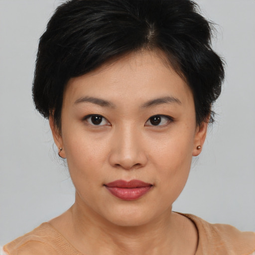 Joyful asian young-adult female with medium  brown hair and brown eyes