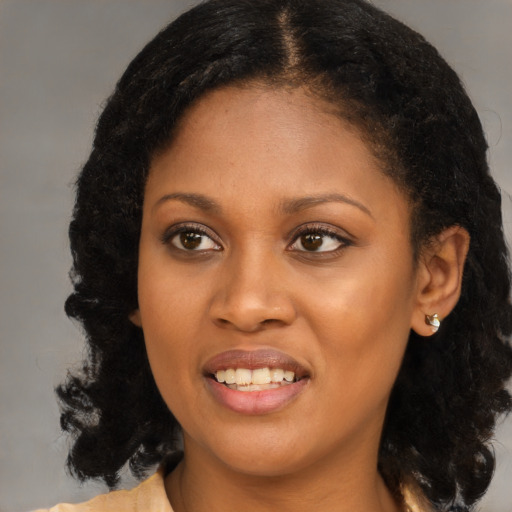 Joyful black young-adult female with medium  brown hair and brown eyes