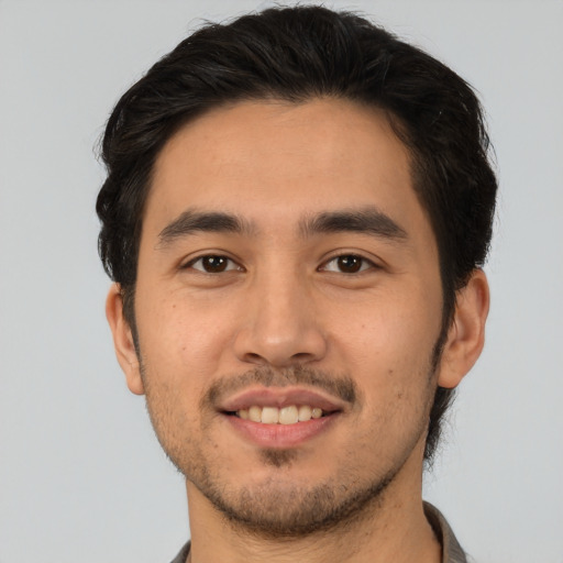 Joyful white young-adult male with short  black hair and brown eyes