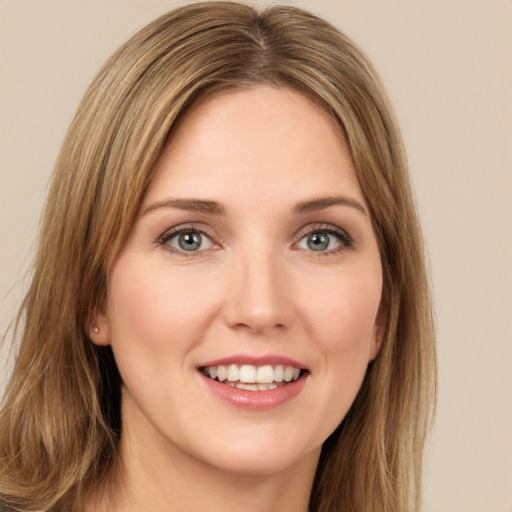 Joyful white young-adult female with long  brown hair and green eyes