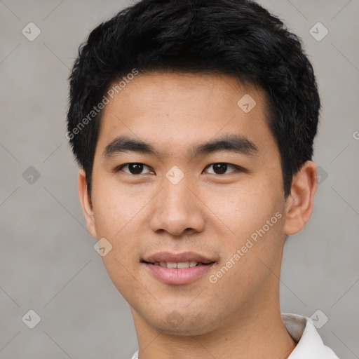 Joyful asian young-adult male with short  black hair and brown eyes