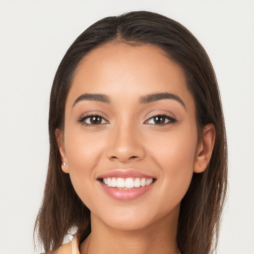 Joyful white young-adult female with long  brown hair and brown eyes