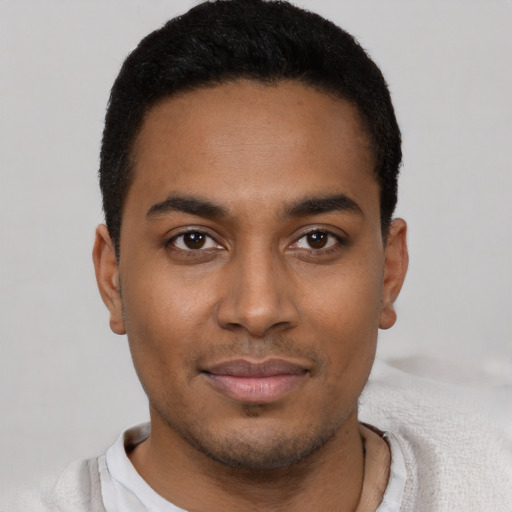 Joyful latino young-adult male with short  black hair and brown eyes