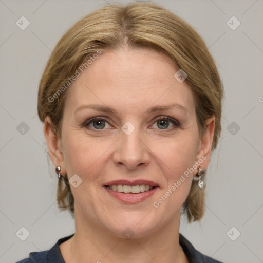 Joyful white adult female with medium  brown hair and grey eyes