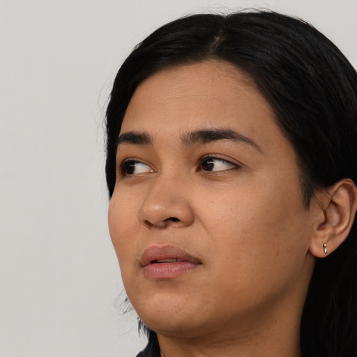 Joyful asian young-adult female with long  black hair and brown eyes