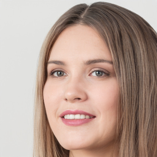 Joyful white young-adult female with long  brown hair and green eyes