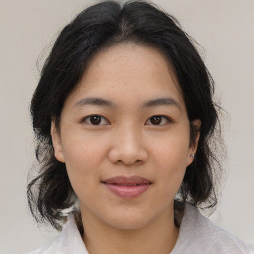 Joyful asian young-adult female with medium  brown hair and brown eyes