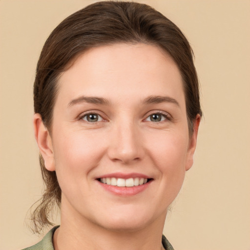 Joyful white young-adult female with short  brown hair and grey eyes