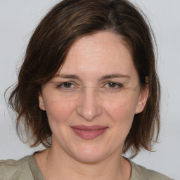 Joyful white adult female with medium  brown hair and brown eyes