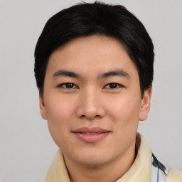 Joyful asian young-adult male with short  black hair and brown eyes