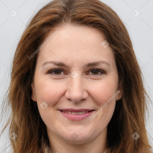 Joyful white adult female with long  brown hair and brown eyes