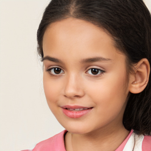 Joyful white child female with long  brown hair and brown eyes