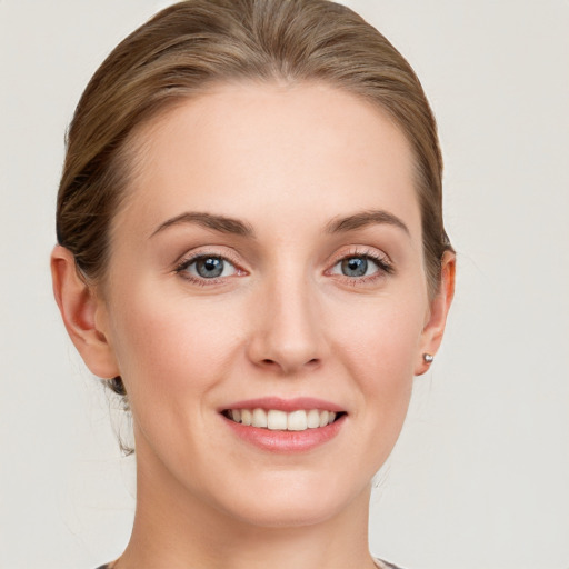 Joyful white young-adult female with medium  brown hair and blue eyes