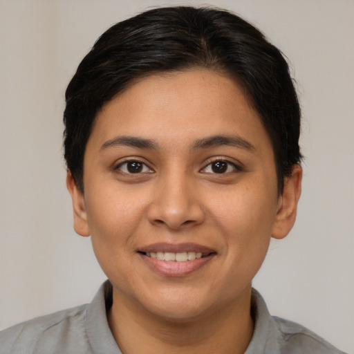 Joyful latino young-adult female with short  brown hair and brown eyes