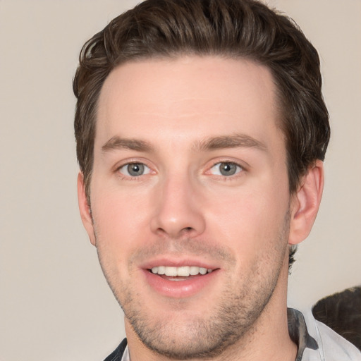 Joyful white young-adult male with short  brown hair and brown eyes