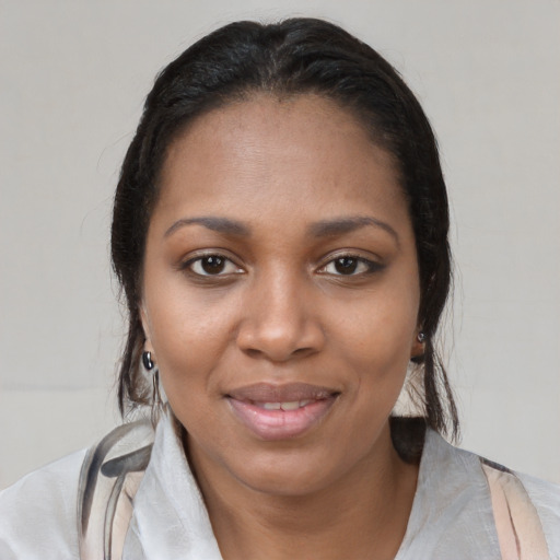 Joyful latino young-adult female with medium  black hair and brown eyes