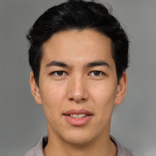 Joyful asian young-adult male with short  black hair and brown eyes