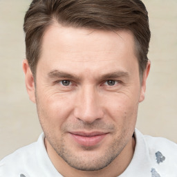 Joyful white adult male with short  brown hair and brown eyes