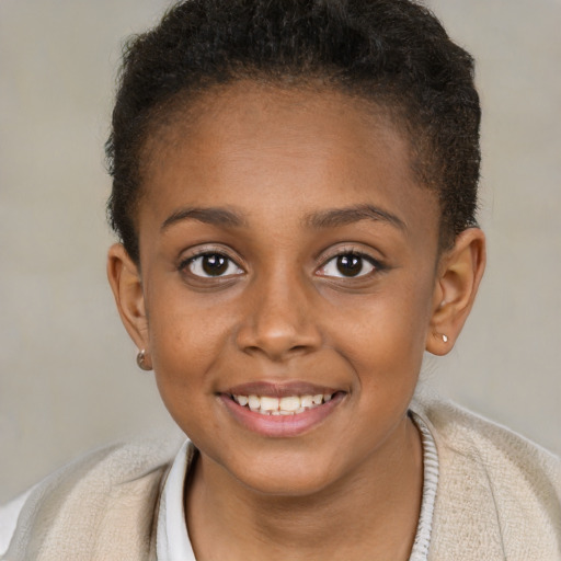 Joyful black child female with short  brown hair and brown eyes