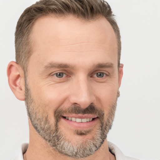 Joyful white adult male with short  brown hair and brown eyes