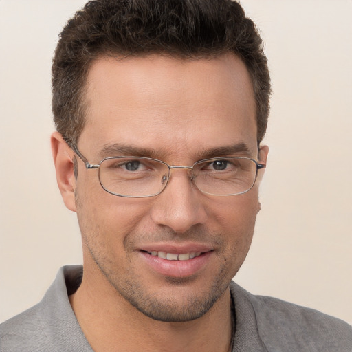 Joyful white young-adult male with short  brown hair and brown eyes