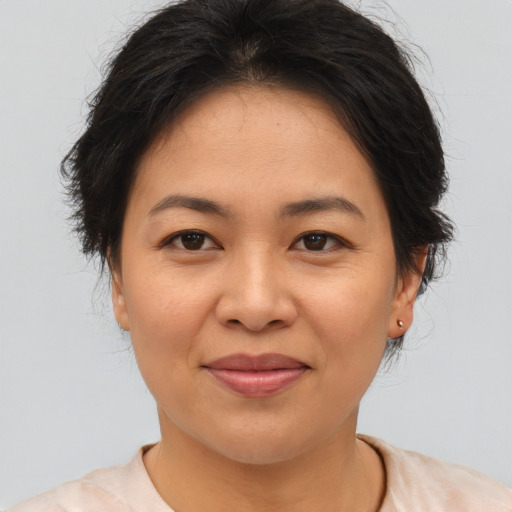 Joyful asian young-adult female with short  brown hair and brown eyes