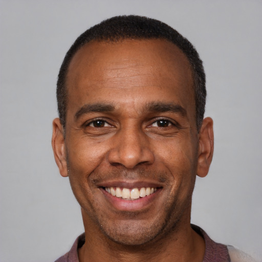 Joyful latino adult male with short  brown hair and brown eyes
