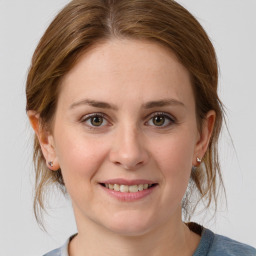 Joyful white young-adult female with medium  brown hair and grey eyes