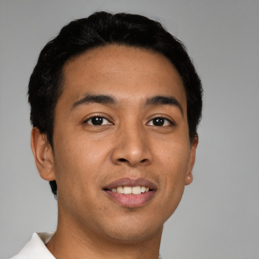 Joyful latino young-adult male with short  brown hair and brown eyes