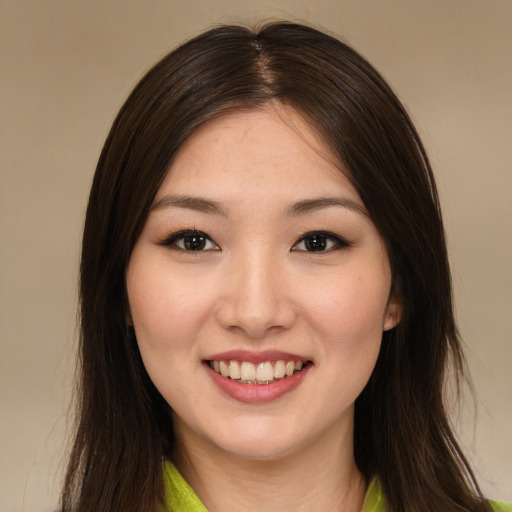 Joyful asian young-adult female with long  brown hair and brown eyes