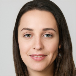 Joyful white young-adult female with long  brown hair and green eyes