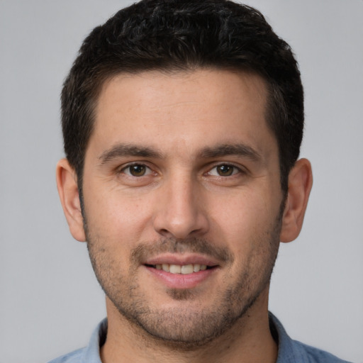 Joyful white young-adult male with short  brown hair and brown eyes