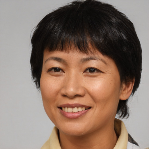 Joyful asian adult female with medium  brown hair and brown eyes