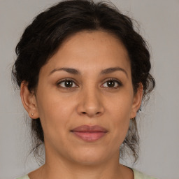 Joyful white adult female with medium  brown hair and brown eyes