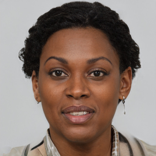 Joyful black young-adult female with short  brown hair and brown eyes