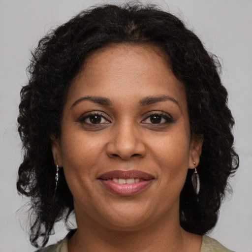 Joyful black young-adult female with medium  brown hair and brown eyes