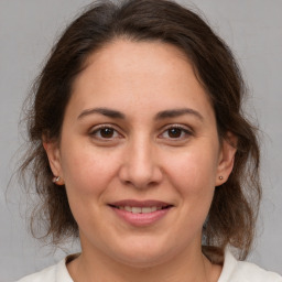 Joyful white adult female with medium  brown hair and brown eyes