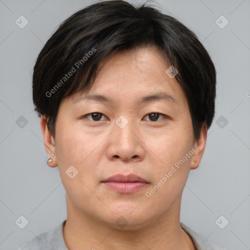 Joyful asian adult male with short  brown hair and brown eyes