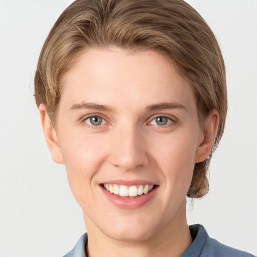 Joyful white young-adult female with medium  brown hair and grey eyes