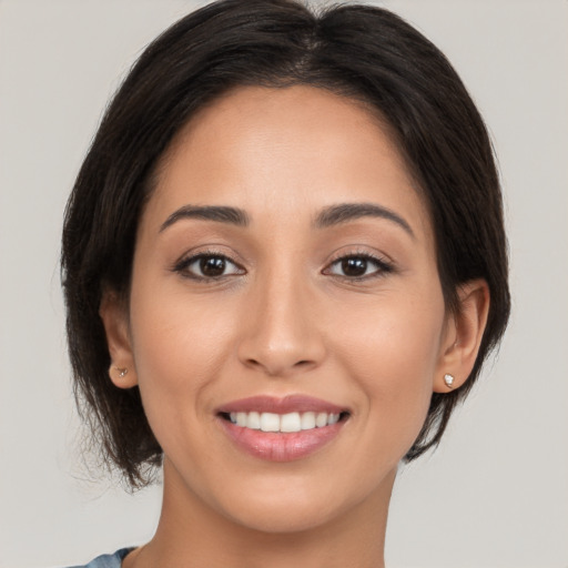 Joyful white young-adult female with medium  brown hair and brown eyes