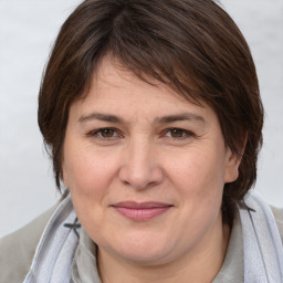 Joyful white adult female with medium  brown hair and brown eyes