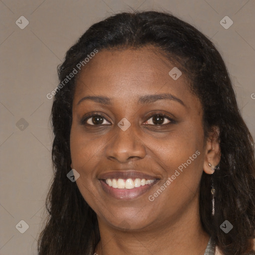 Joyful black young-adult female with long  brown hair and brown eyes