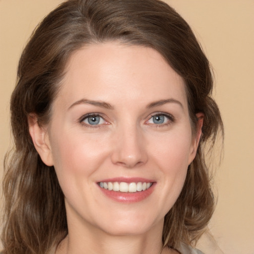 Joyful white young-adult female with medium  brown hair and grey eyes