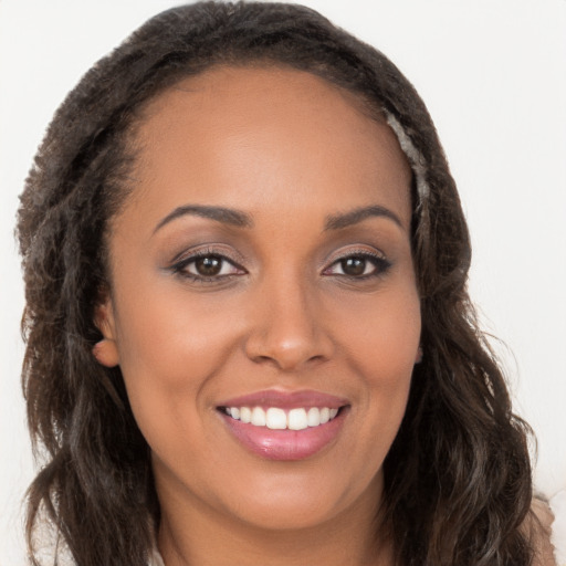 Joyful white young-adult female with long  brown hair and brown eyes