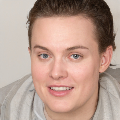 Joyful white young-adult female with medium  brown hair and blue eyes