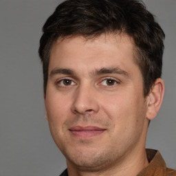 Joyful white young-adult male with short  brown hair and brown eyes