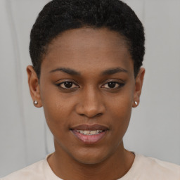 Joyful black young-adult female with short  brown hair and brown eyes